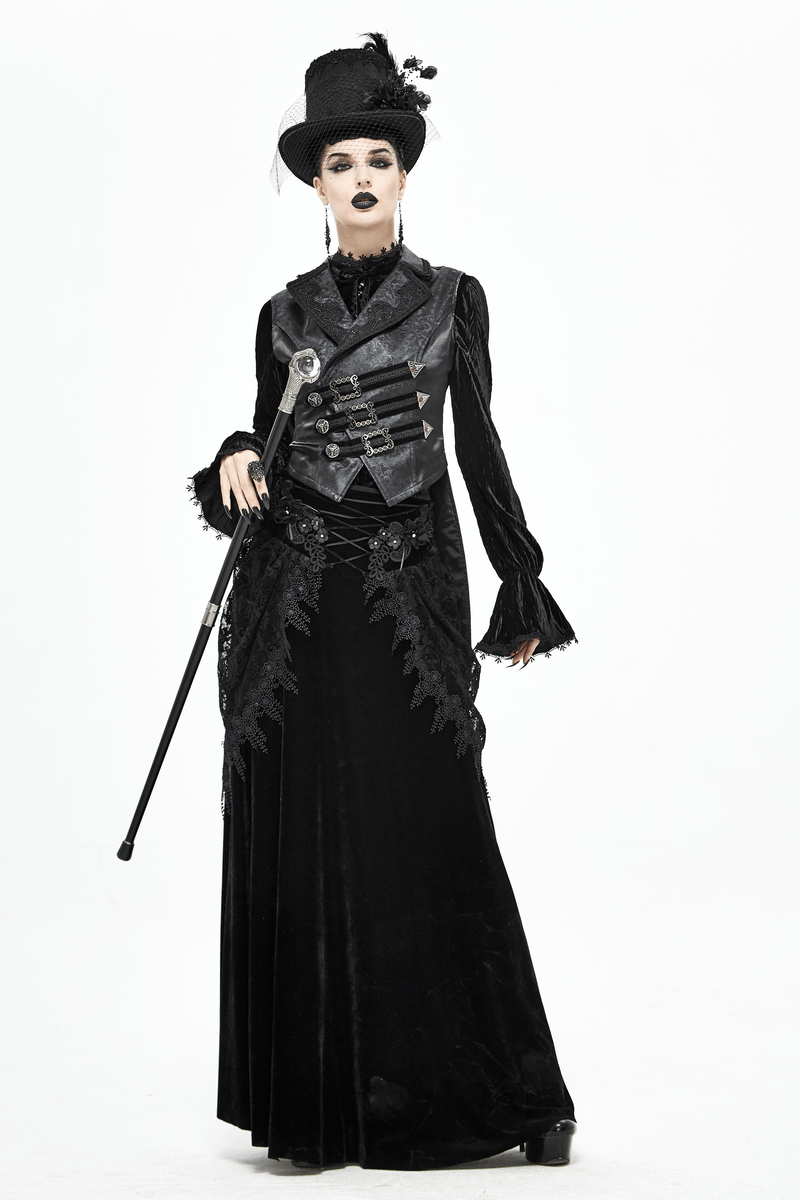 Gothic fashion model in elegant black attire holding a dragon claw cane, showcasing a dramatic style.