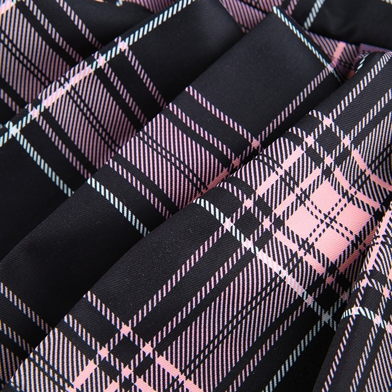 Close-up of gothic checkered fabric in black and pink, showcasing stylish plaid print for mini skirt fashion.