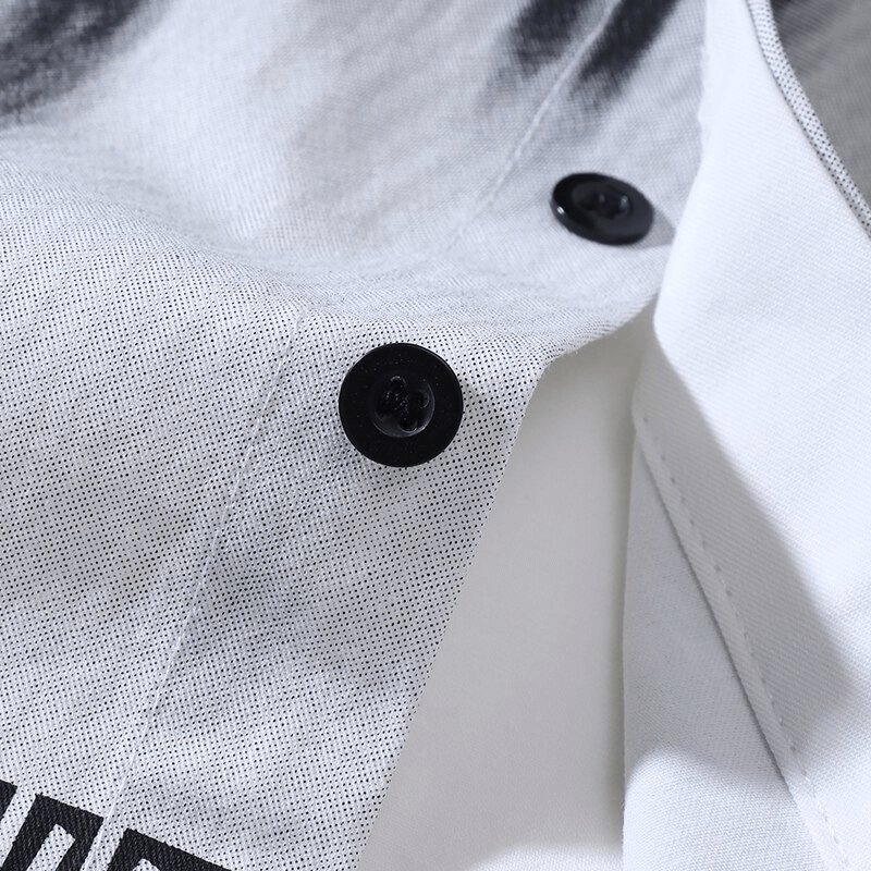 Close-up of black buttons on a stylish white shirt with a textured fabric, ideal for casual and gothic outfits.