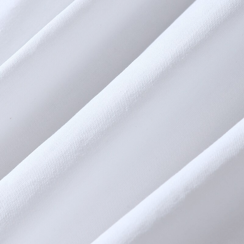 Close-up of smooth white fabric showcasing its texture and quality for apparel.