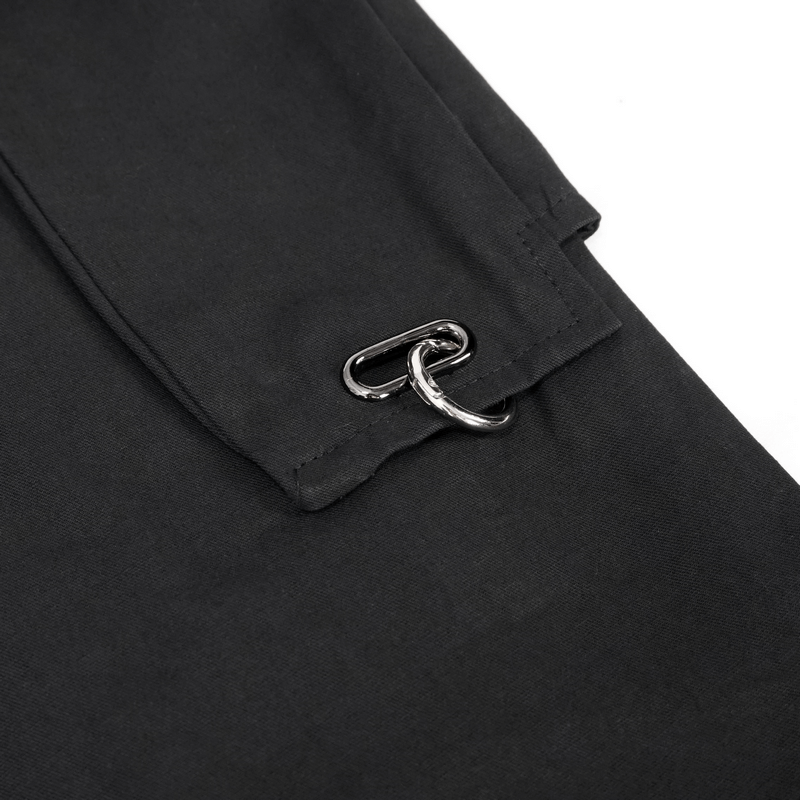 Close-up of black punk cargo pants showcasing shiny hoop accent and rivet detail for a trendy look.
