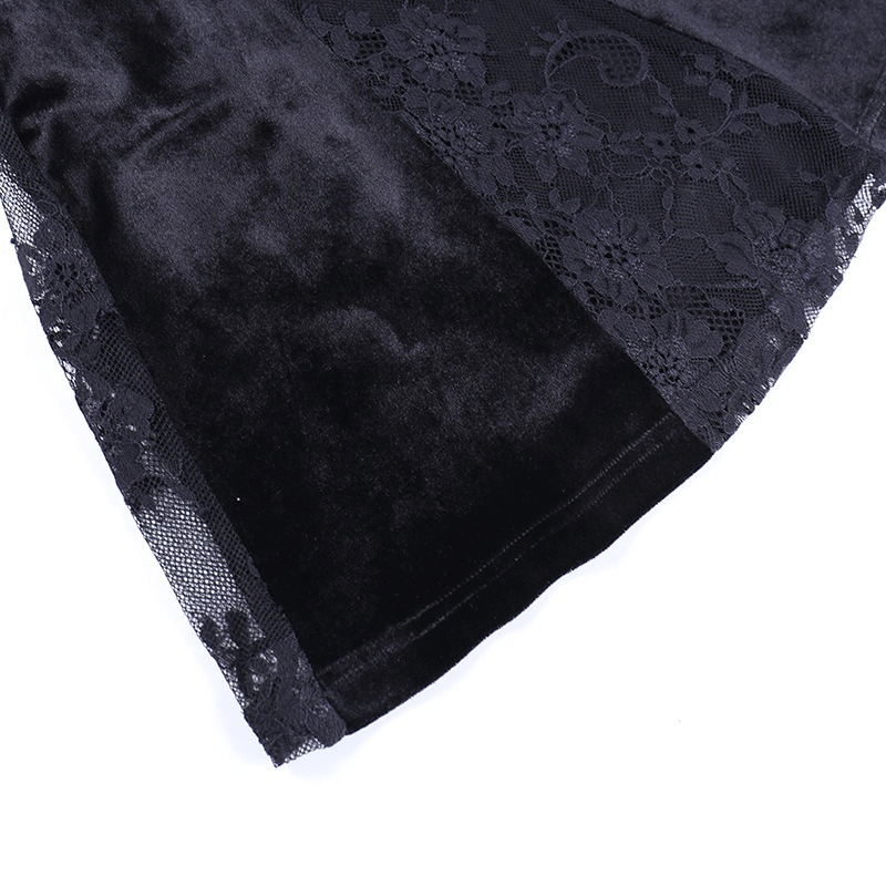 Close-up of a black velvet fabric with lace detailing, showcasing the elegance of a gothic-inspired dress.
