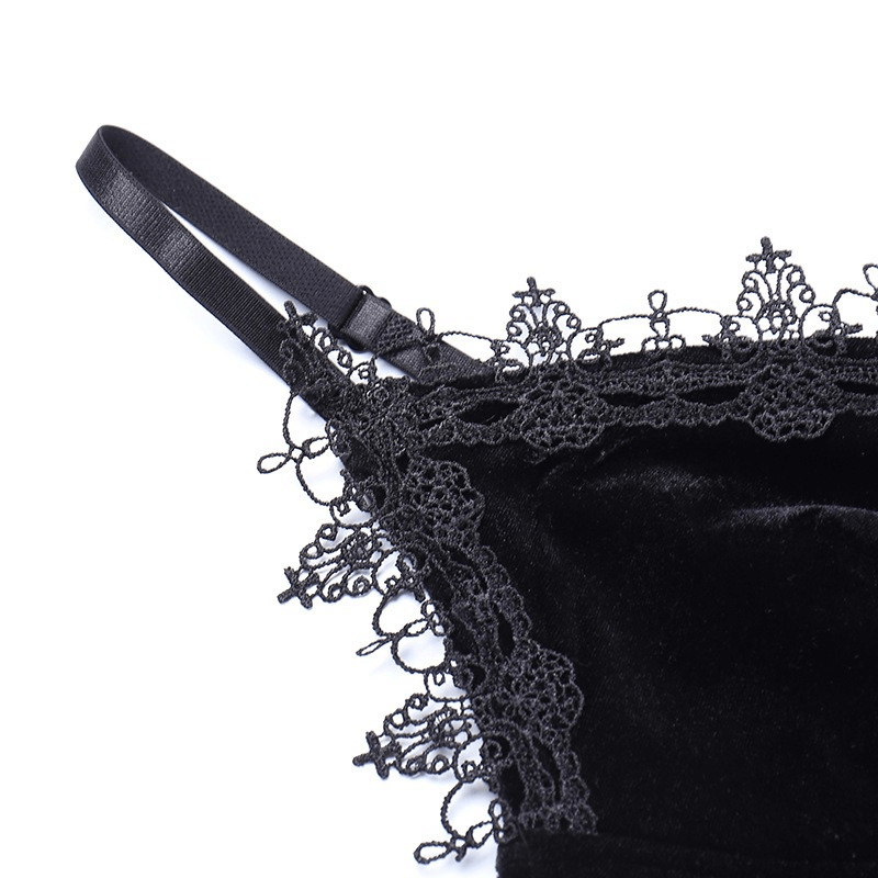 Close-up of the delicate lace trim and strap detail on a black velvet dress for a gothic elegant look.