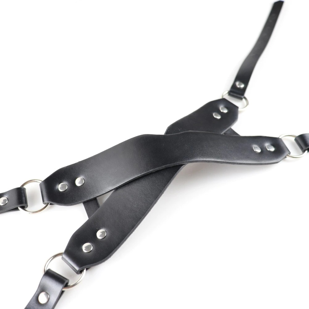 Black synthetic leather harness with metal rings, ideal for gothic and cosplay outfits.