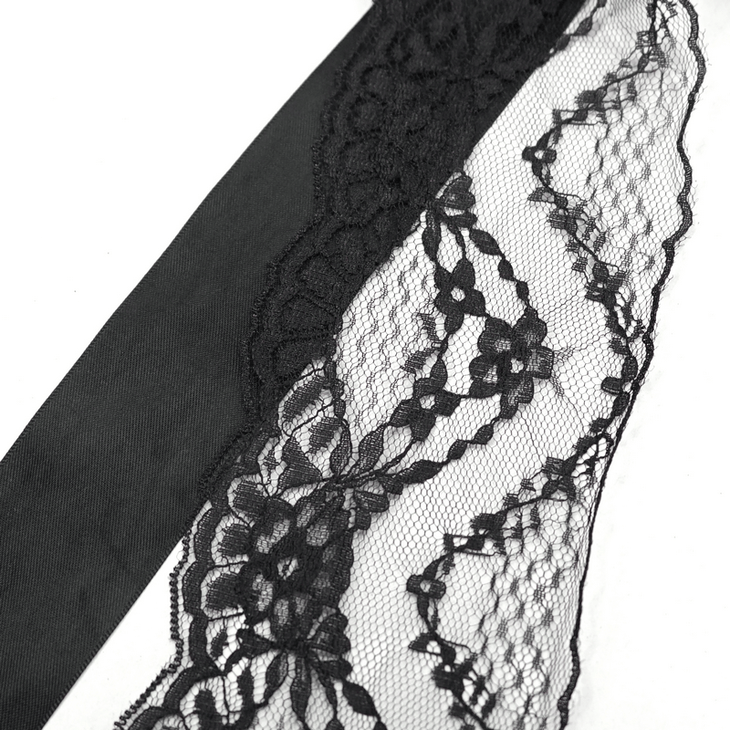 Close-up of intricate black lace detailing on fabric, perfect for gothic-style accessories and floral arrangements.