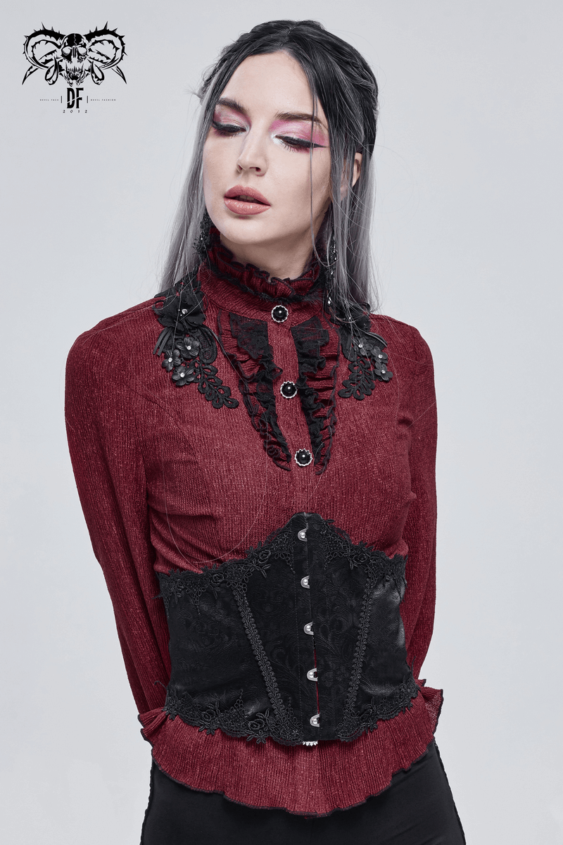 Gothic fashion model wearing a black floral lace corset over a red blouse with intricate lace details.