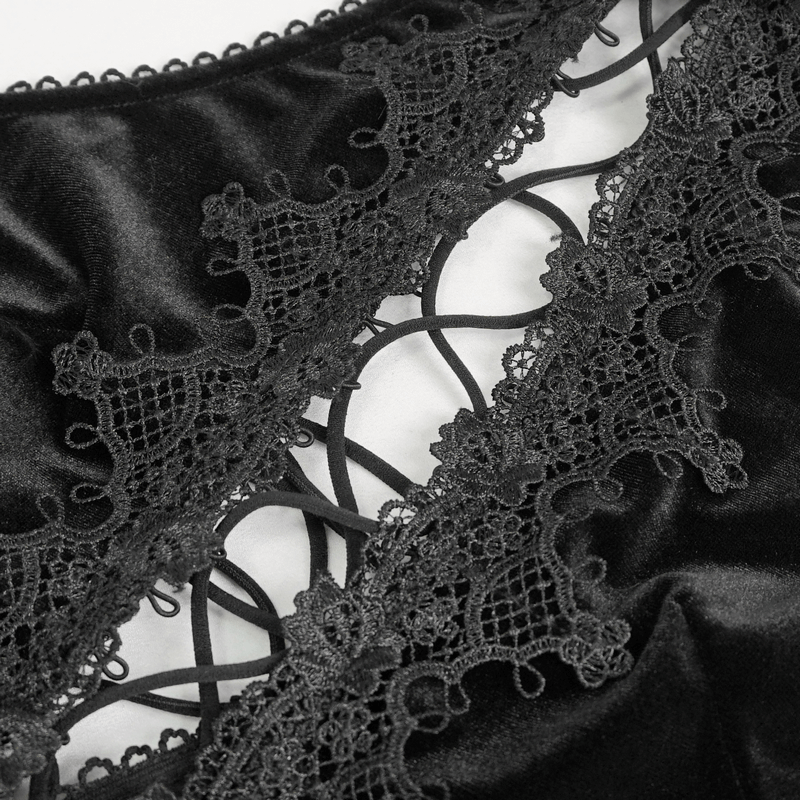 Close-up of intricate lace detailing on a gothic halterneck velvet black dress.