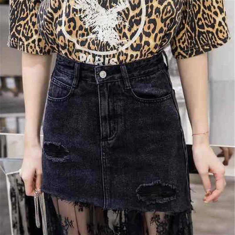 Gothic black denim midi skirt with lace insert, styled with a leopard print top, perfect for edgy fashion looks.