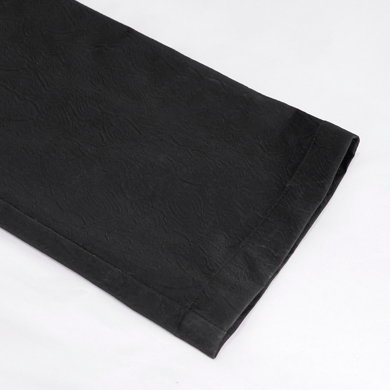 Close-up of vintage gothic high waist pants with textured black fabric and intricate jacquard design.