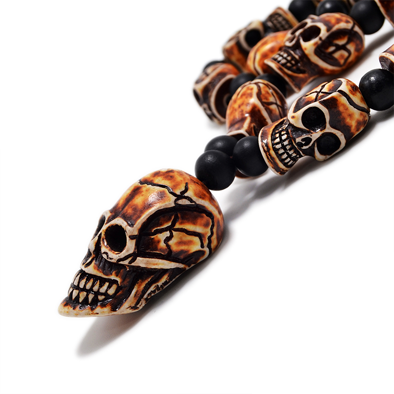 Gothic imitation bone necklace with skull pendant, featuring detailed resin skull beads and black accents, perfect for cosplay.