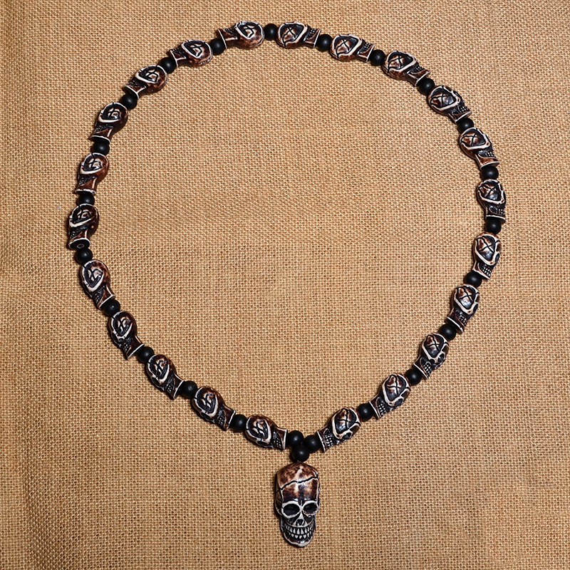 Gothic imitation bone necklace featuring skull pendant and intricate details, perfect for rock concerts and cosplay.