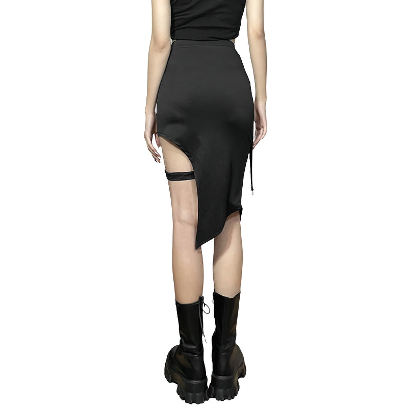 Gothic black mini skirt with irregular hem and edgy patchwork design, stylishly paired with knee-high boots.