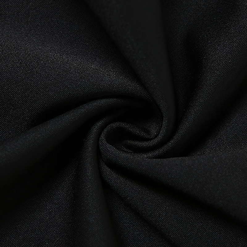 Close-up of soft black fabric, perfect for gothic and grunge fashion designs, showcasing smooth texture and rich color.