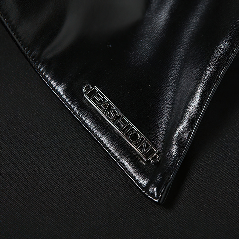 Close-up of a black fabric with a silver 'FASHION' label, showcasing stylish details of gothic clothing.