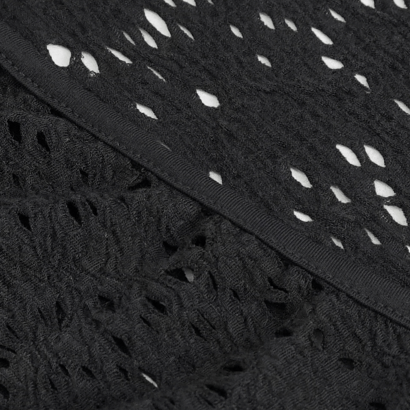 Close-up of textured black fabric featuring intricate openwork pattern, perfect for a gothic dress.
