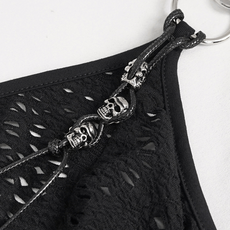Close-up of skull chain detail on a gothic black dress, showcasing edgy style and unique design.