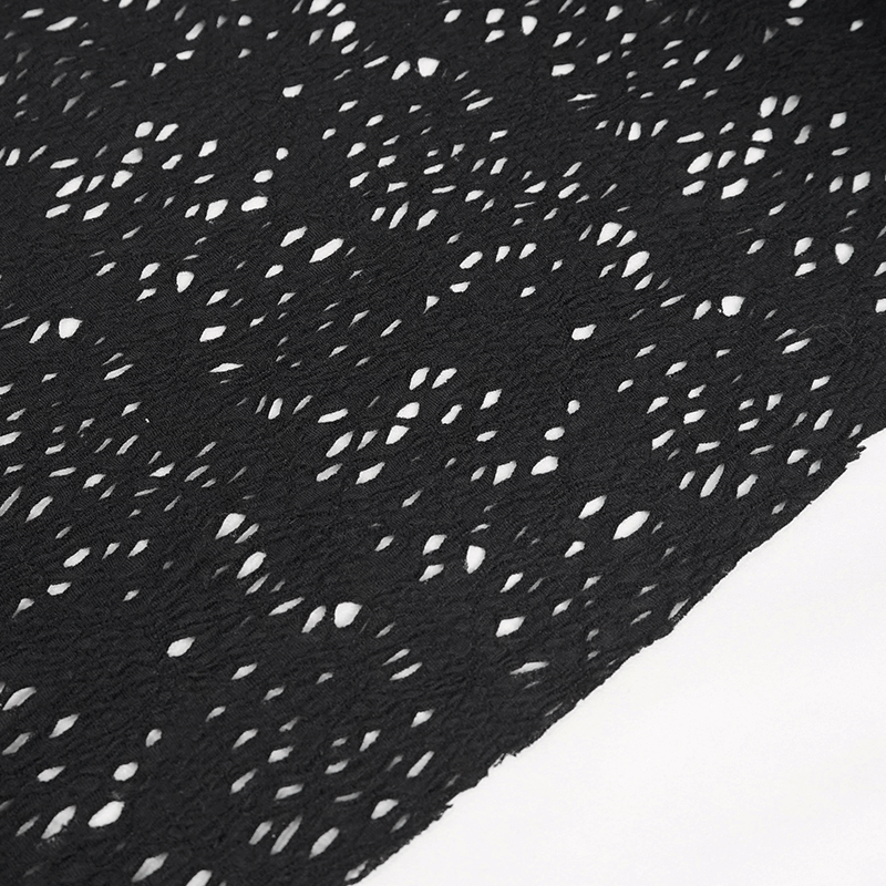 Close-up of intricate black lace fabric showcasing an asymmetric ripped design for gothic fashion.