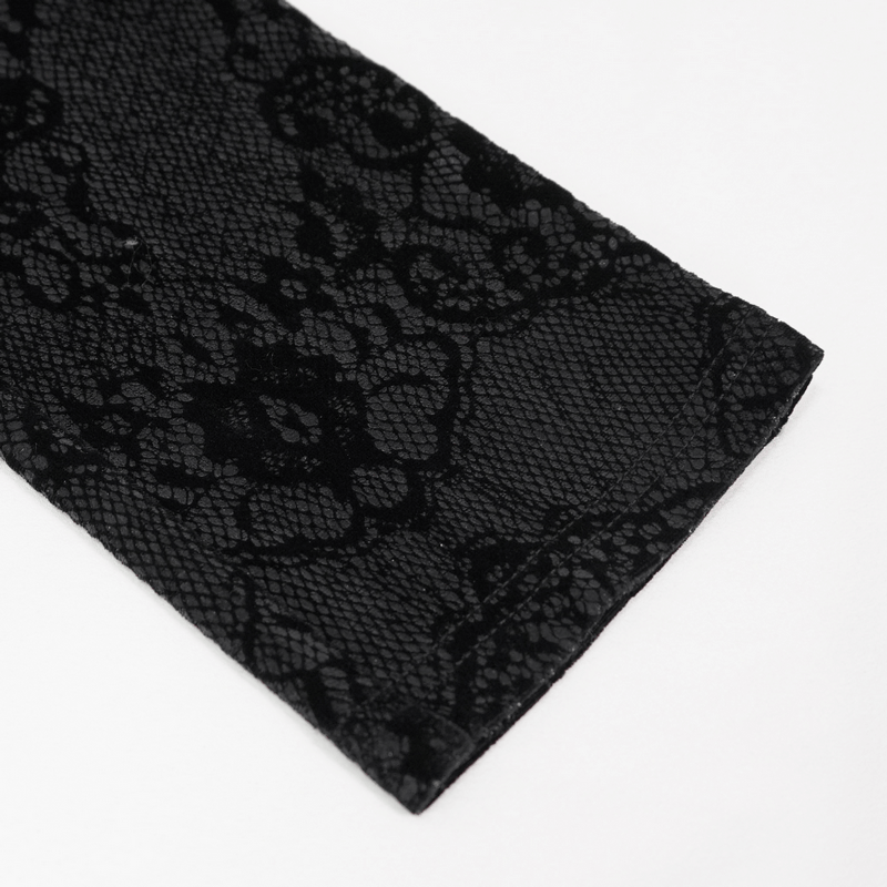 Close-up of black lace overlay on faux leather leggings, showcasing intricate floral applique design.