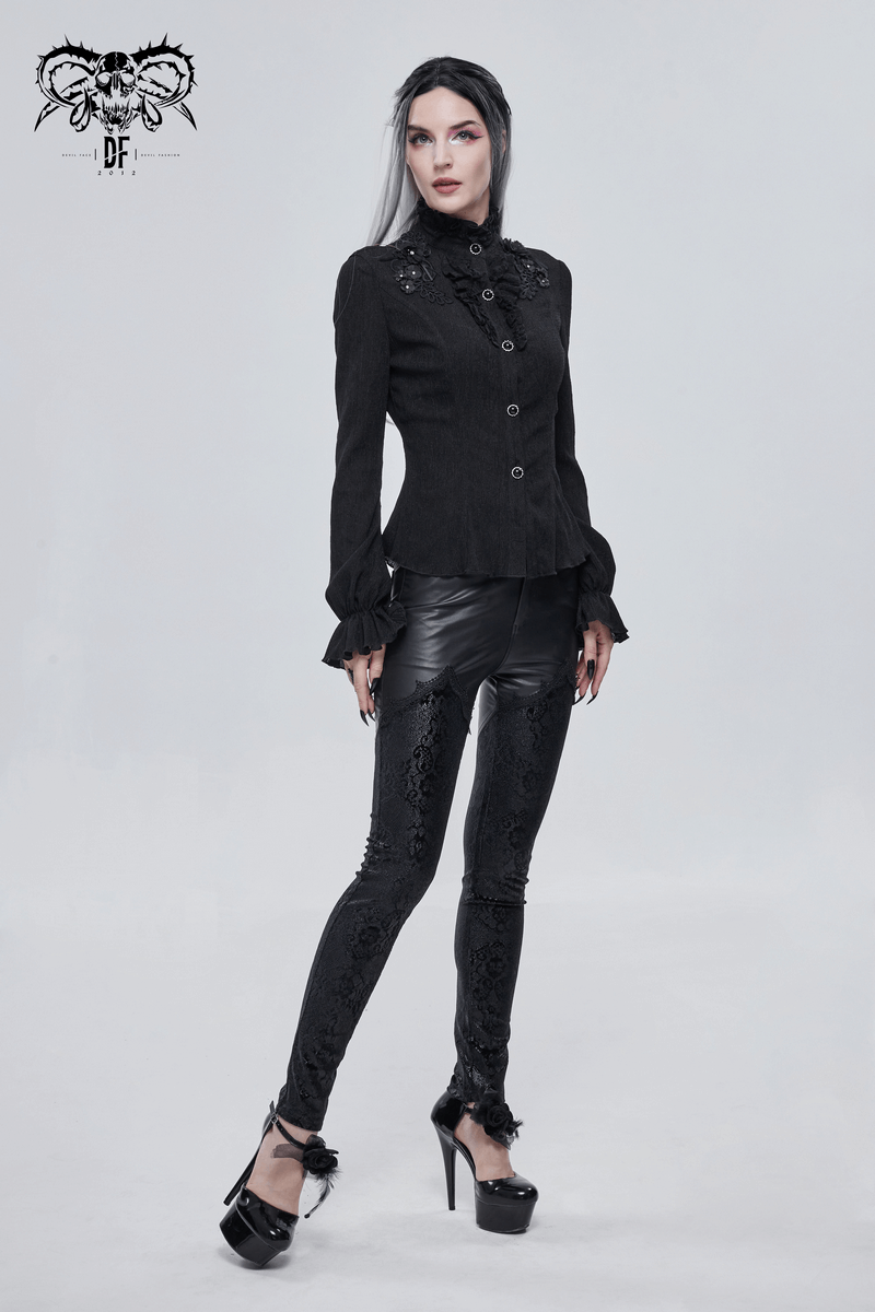 Fashionable woman in gothic lace applique faux leather leggings and stylish black blouse, posing confidently.