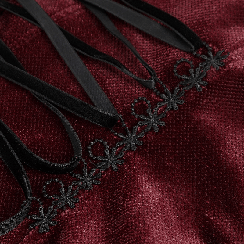 Close-up of intricate black lace and ribbon detailing on wine red velvet fabric, perfect for a gothic style blouse.