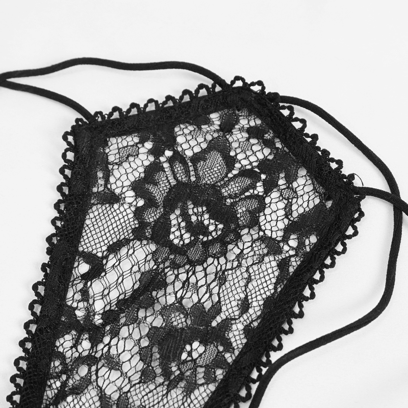 Close-up of black lace fabric showcasing intricate floral patterns for gothic lingerie set.