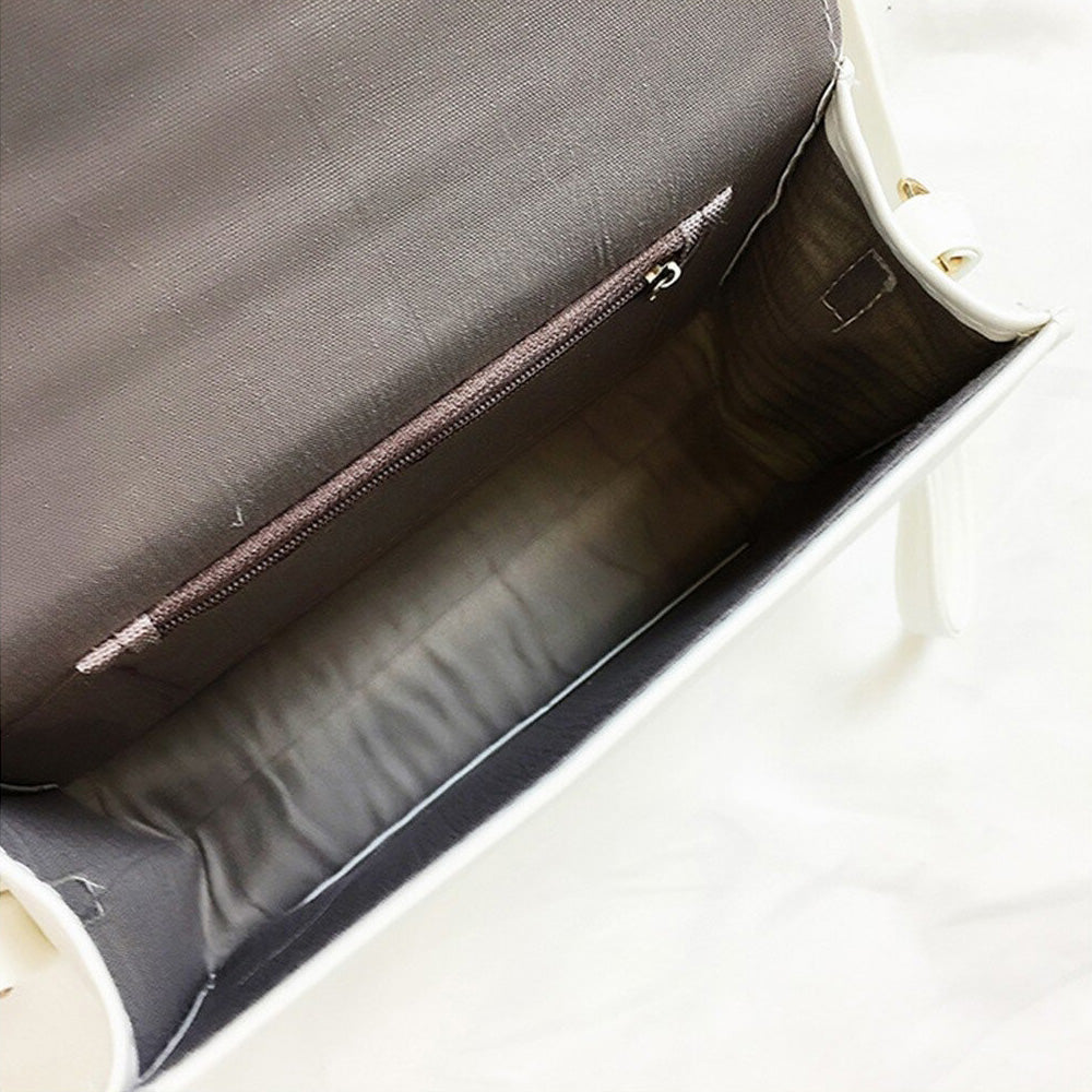Interior view of Gothic letter printing shoulder bag, showcasing a spacious compartment with a zip pocket.