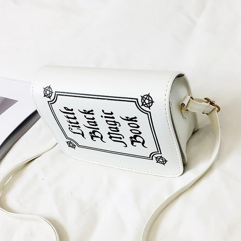 Gothic letter printed shoulder bag with 'Little Black Magic Book' design, perfect for alternative fashion enthusiasts.