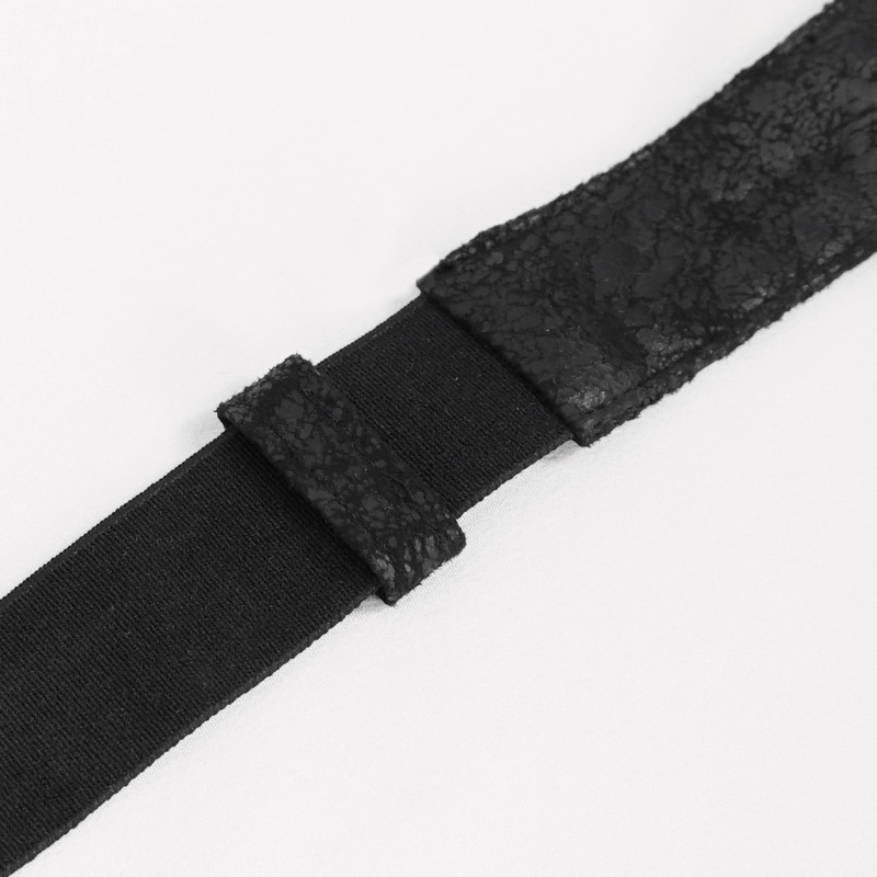 Close-up of a black lace and elastic strap, perfect for gothic fashion or costume accessories.