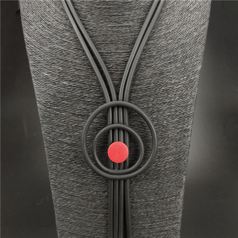 Close-up of a handmade gothic long tassel necklace featuring black rubber cords and a red accent.