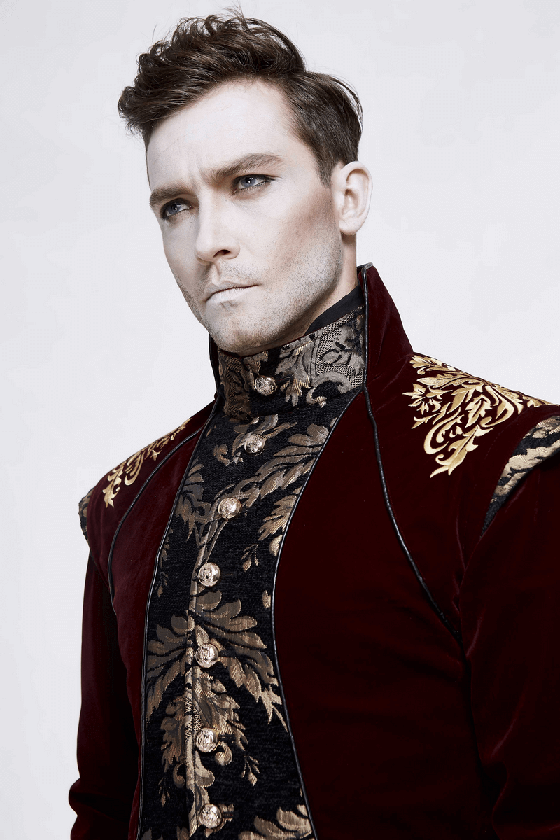 Gothic male model in wine red long tail coat with gold patterns, showcasing vintage style and elegance.
