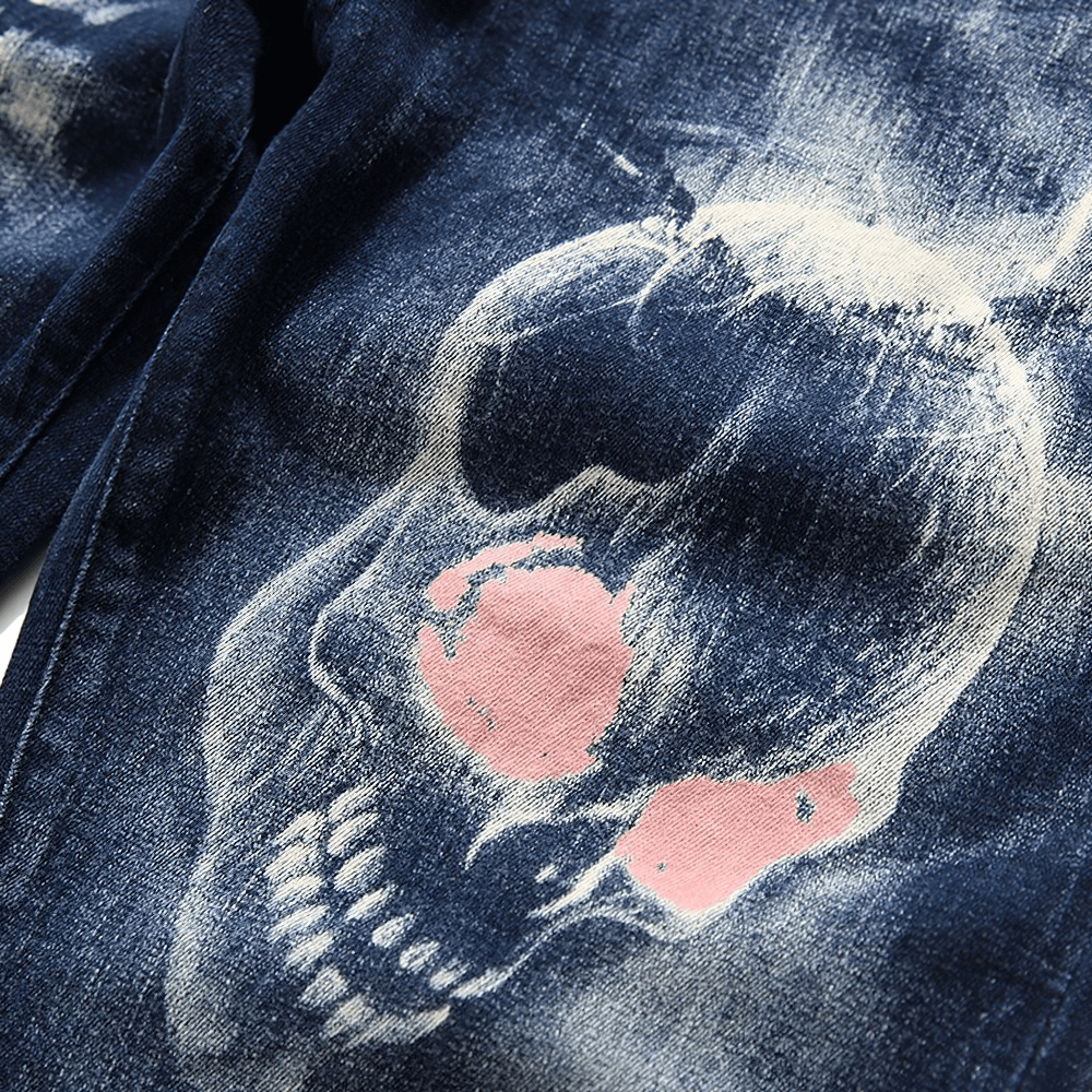 Gothic men's stretch jeans featuring a striking 3D skull print on a dark denim background.