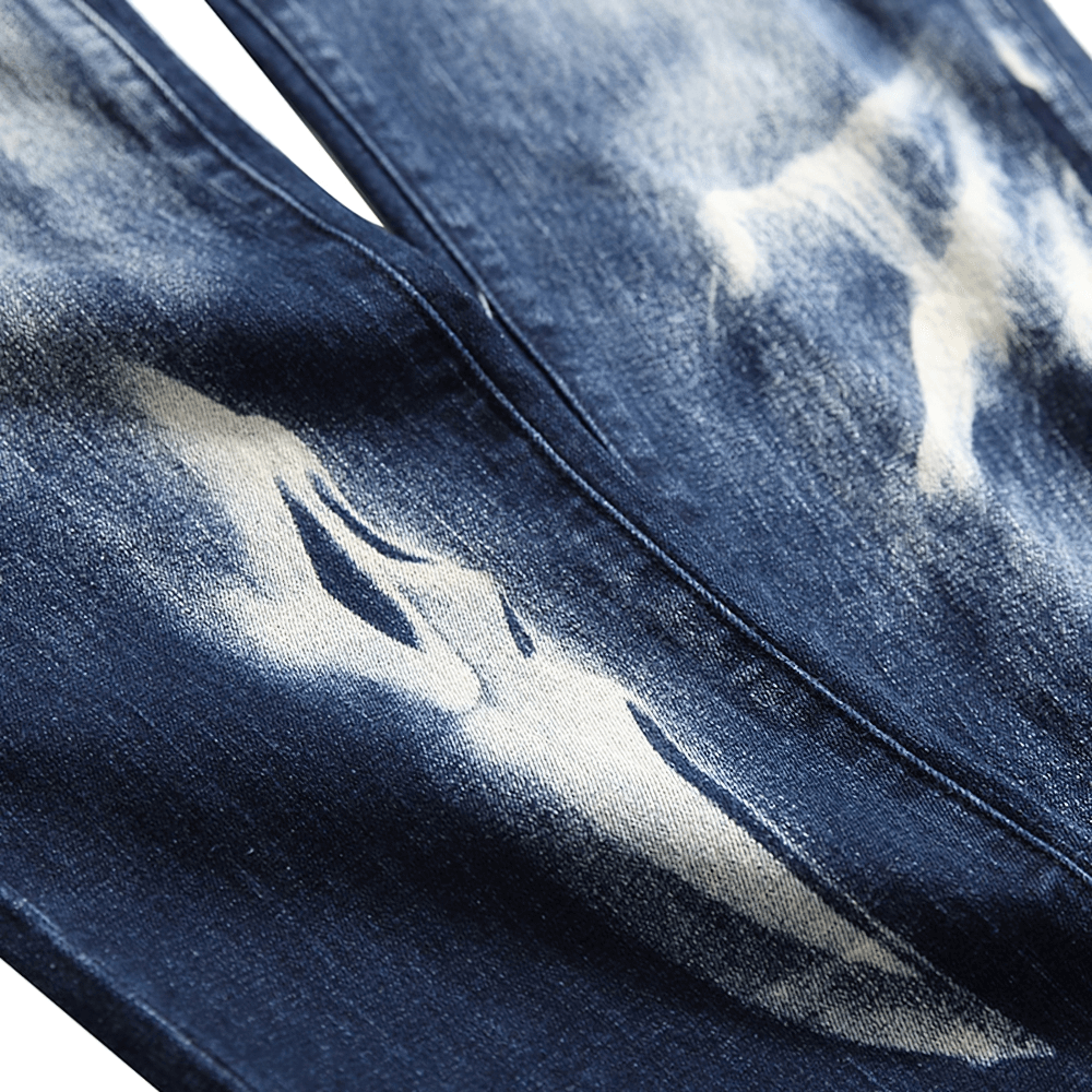 Close-up of Gothic men's stretch jeans featuring unique 3D print design on dark denim fabric.