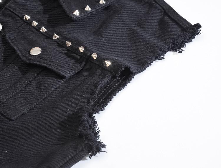 Close-up of Gothic men's studded denim vest showcasing rivets and frayed edges, perfect for alternative fashion lovers.