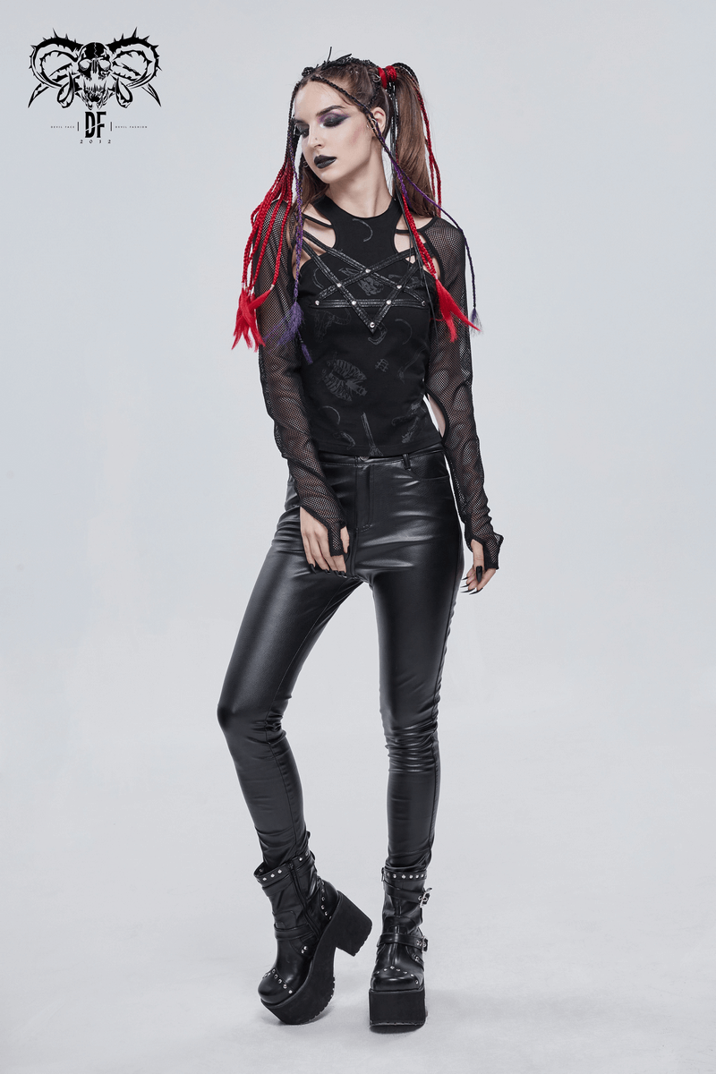 Stylish gothic women's top with cutout shoulders and mesh sleeves, paired with black pants and platform boots.