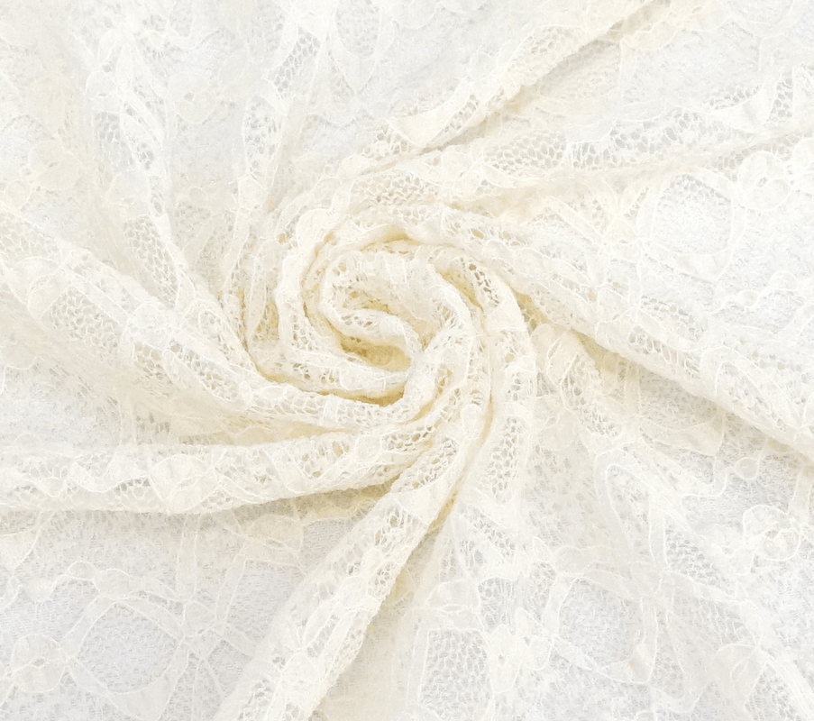 Delicate off-white lace fabric in a spiral pattern, perfect for gothic vintage clothing and elegant designs.