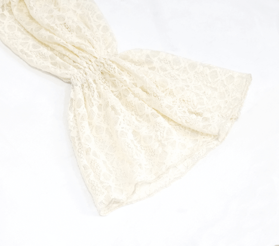 Elegant beige lace sleeve detail of a gothic off-shoulder women's top showcasing vintage craftsmanship.