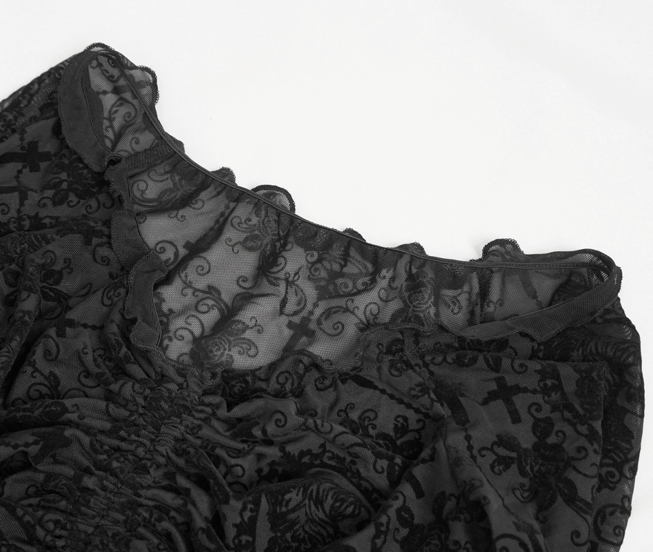 Close-up of a gothic off-shoulder black lace top with intricate patterns and drawstring detail.