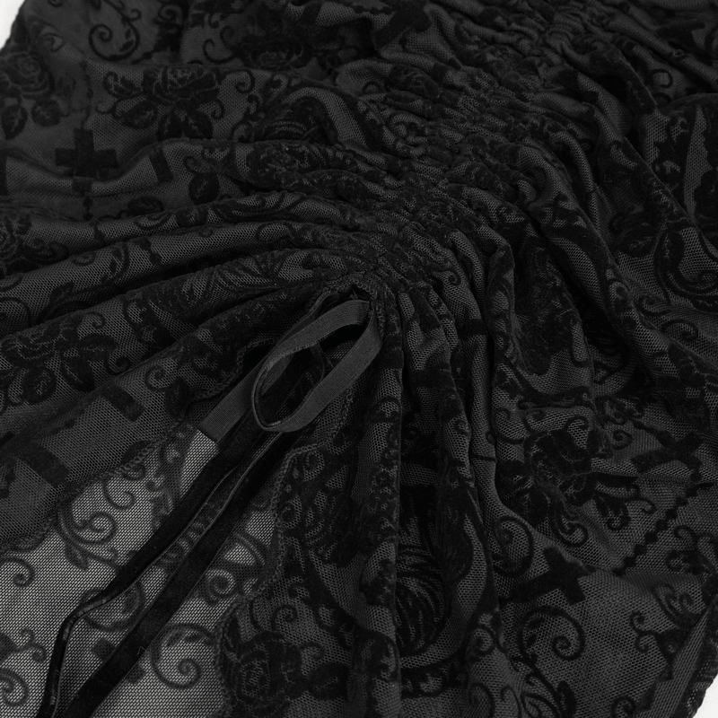 Close-up of black lace fabric with gothic print and drawstring details for stylish off-shoulder top.