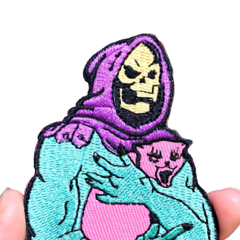 Gothic patch of a skull in a hood holding a cat, a stylish unisex accessory for clothing.