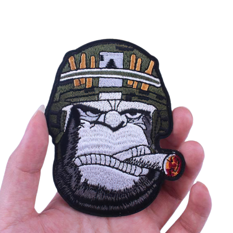 Gothic embroidered patch of a gorilla in a helmet smoking a cigar, perfect for stylish unisex clothing accessories.