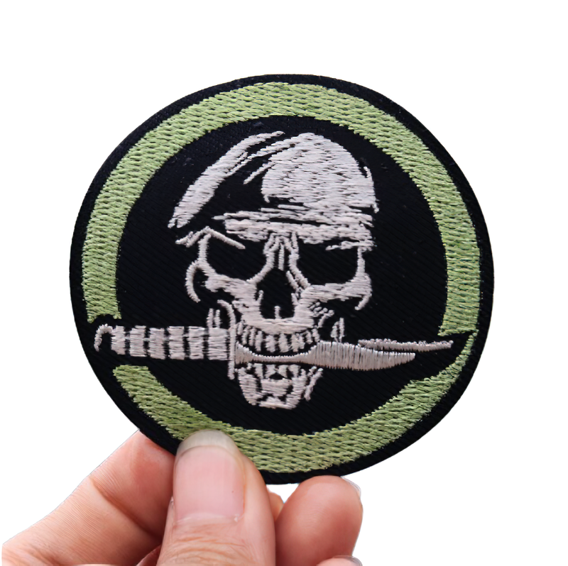 Gothic skull patch with beret and knife in teeth, unisex fashion accessory for style enthusiasts.