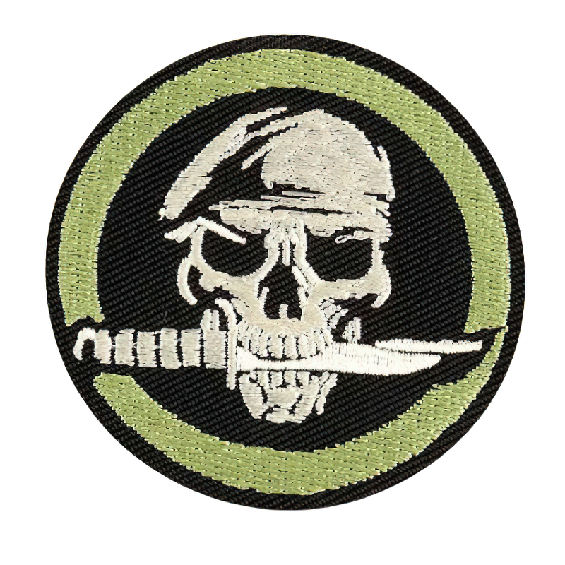 Gothic patch of a skull in a beret with a knife in its teeth, stylish accessory for unisex fashion.
