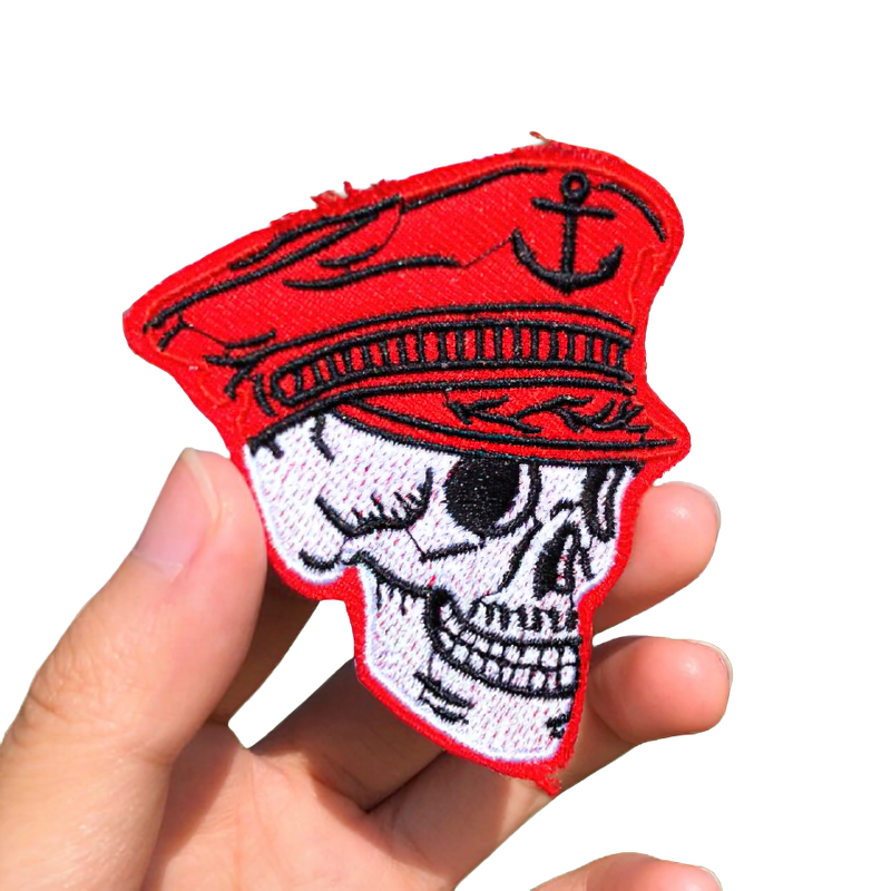 Gothic skull patch in a captain sailor hat, stylish embroidered accessory for clothes, unisex fashion statement.