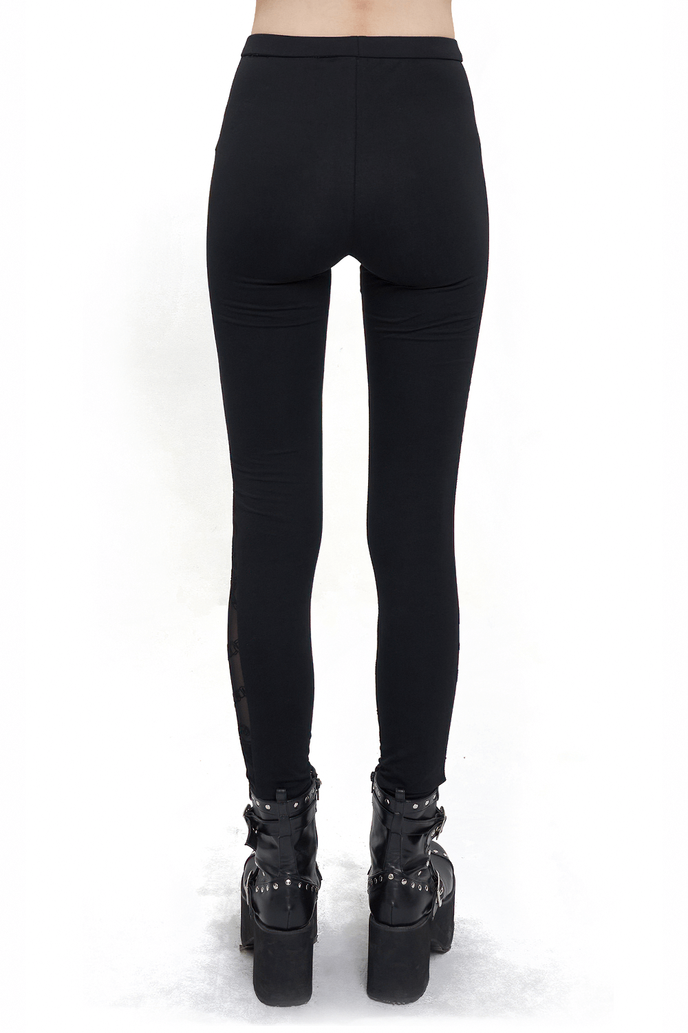 Back view of women's gothic patterned semi-transparent leggings with cross pendant details, paired with stylish boots.