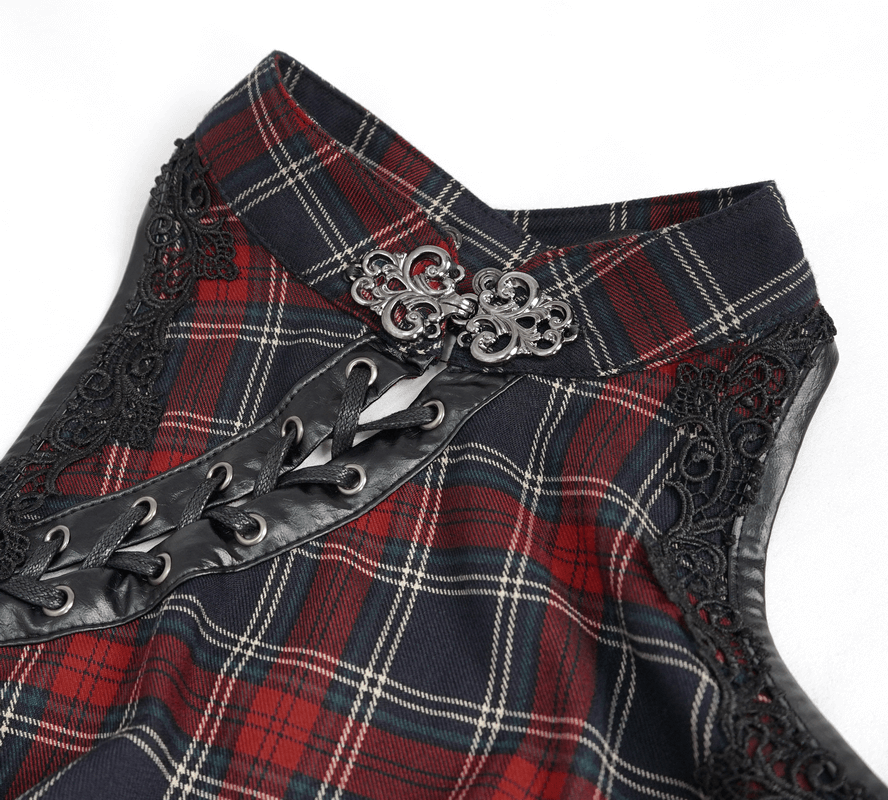 Close-up of gothic plaid dress with ruffled lace hemline and ornate buckle detail.