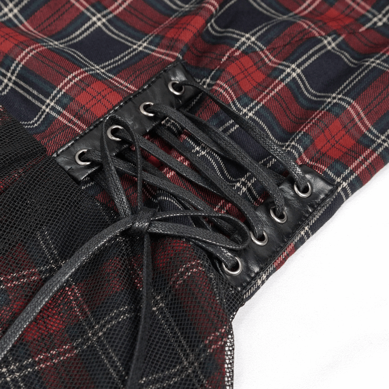 Close-up of Gothic plaid dress showing ruffled lace hemline and black lacing details for a stylish feminine look.