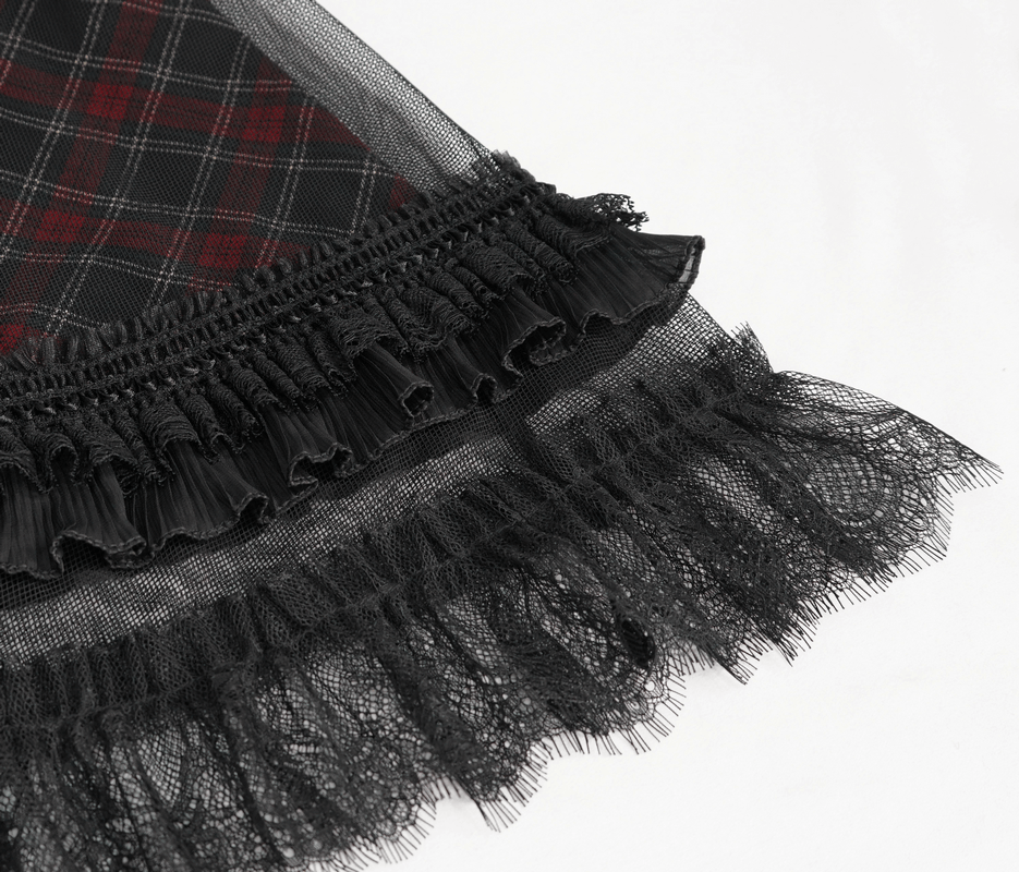 Close-up of the ruffled lace hemline on a gothic plaid dress, showcasing elegant black lace details.