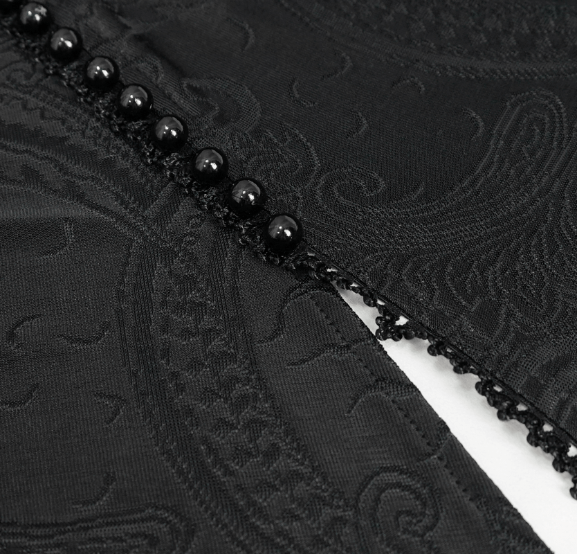 Close-up of intricate black fabric with floral pattern and decorative black buttons for gothic dress.