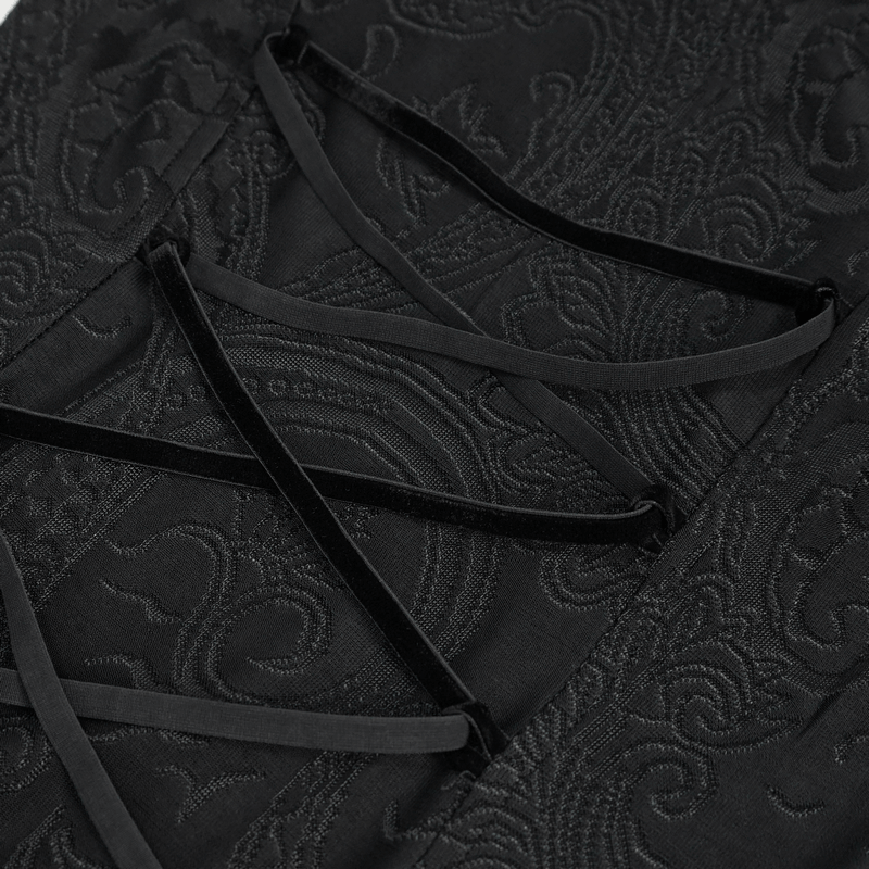 Close-up of gothic floral embroidered black dress detailing with intricate lacing design.
