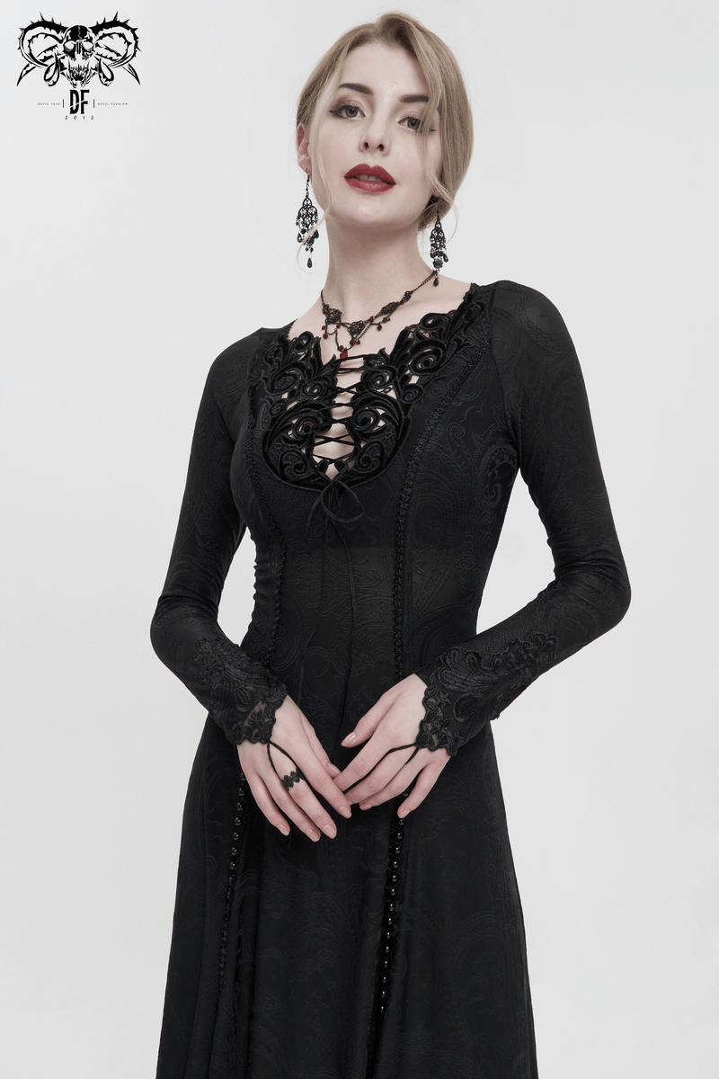 Elegant woman in a black gothic floral dress with lace detailing and a plunging neckline, showcasing dark fashion.